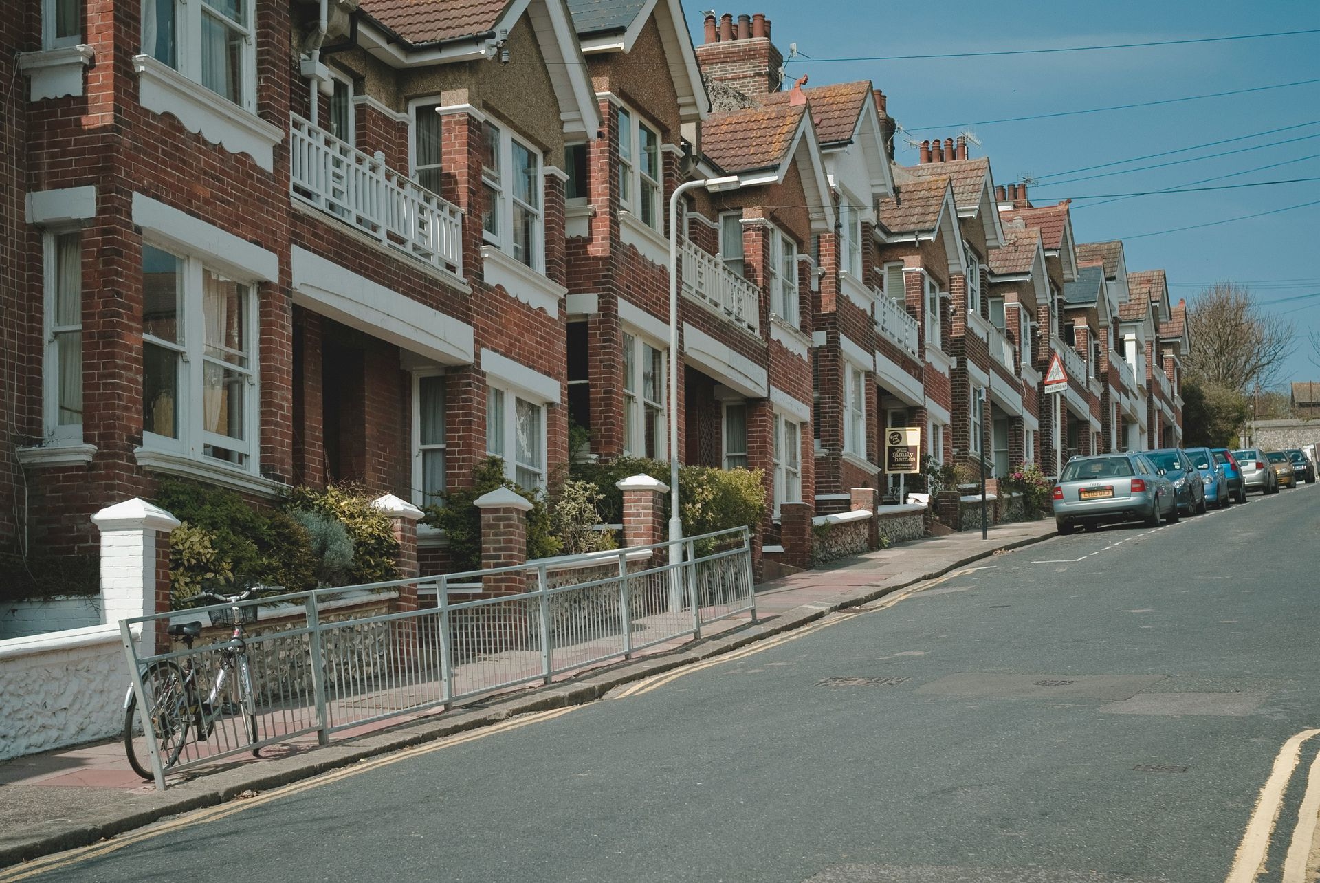 Row of traditional brick terraced houses on a residential street in England, typical buy-to-let property stock