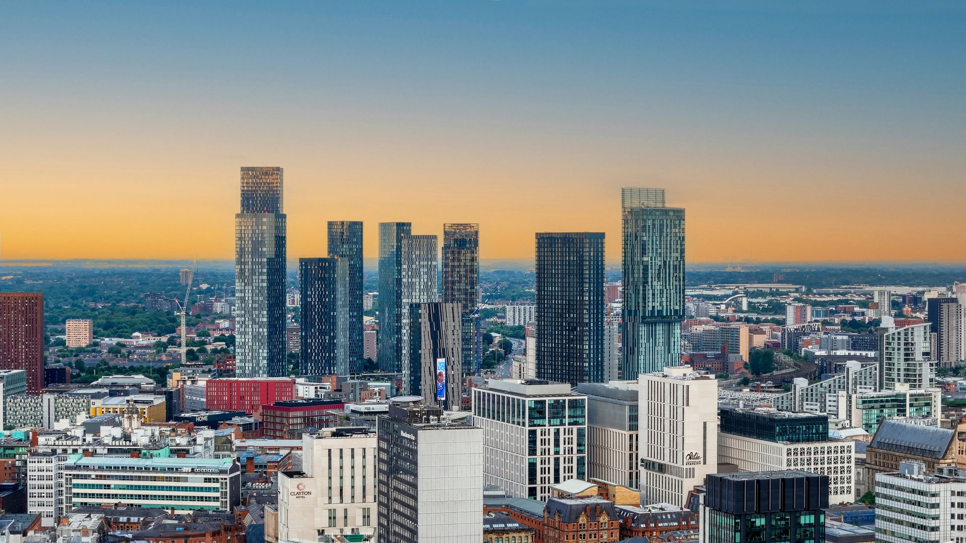 Manchester city skyline at sunset showing the Deansgate Square towers, a key regeneration area for property investment